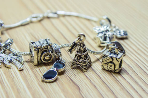 bracelet with charms. selective focus. beauty and fashion. - charming imagens e fotografias de stock