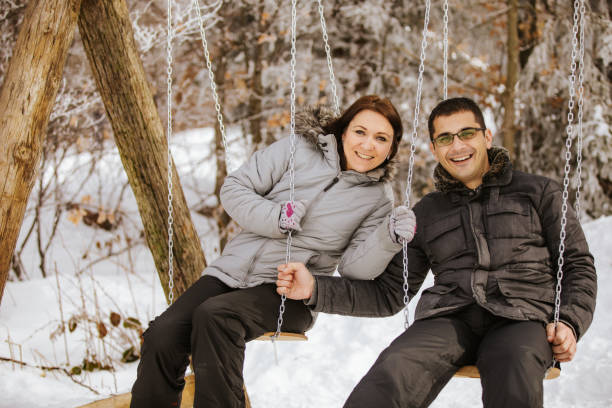 istock Playful couple swinging at winter 1046439522