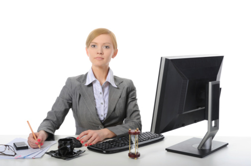 Successful young businesswoman with computer in the office.
