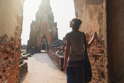 Caucasian female tourist sightseeing Ayuthaya historical park.