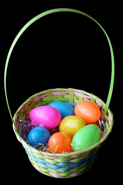 istock Easter Basket with Colorful Eggs Isolated on Black Background 104644686