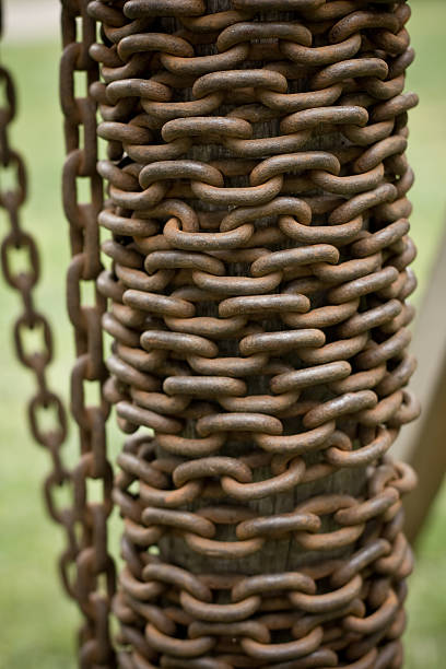 Rusty chain on a bole stock photo