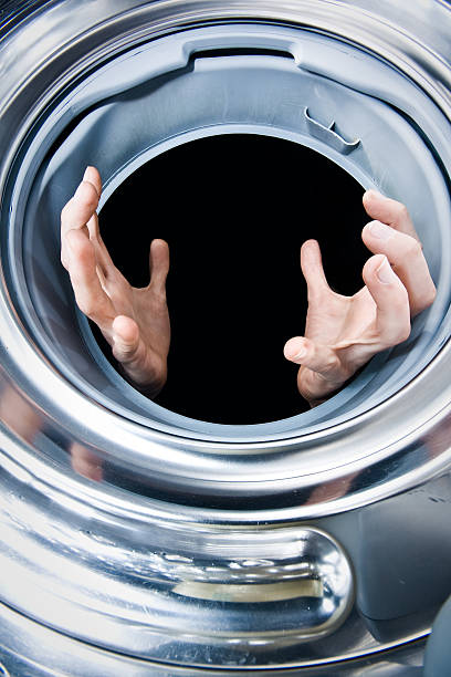 Hands in a washing machine stock photo