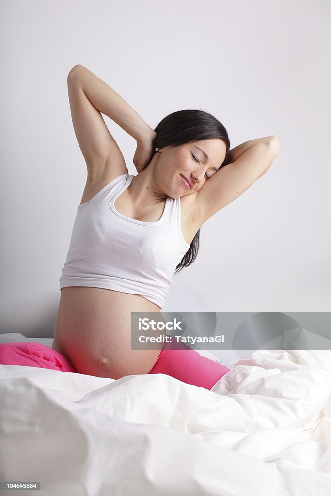Pregnant woman in a bed  Adult Stock Photo