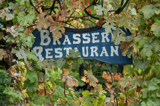 istock restaurant sign on metallic panel in vine leaves on  building facade 1046457518
