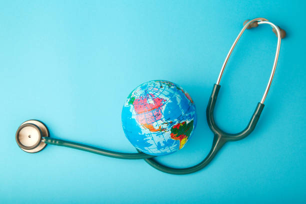 istock World health day ,Stethoscope wrapped around globe on pastel blue background 1046458298