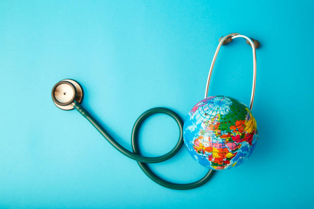 istock World health day ,Stethoscope wrapped around globe on pastel blue background 1046458348
