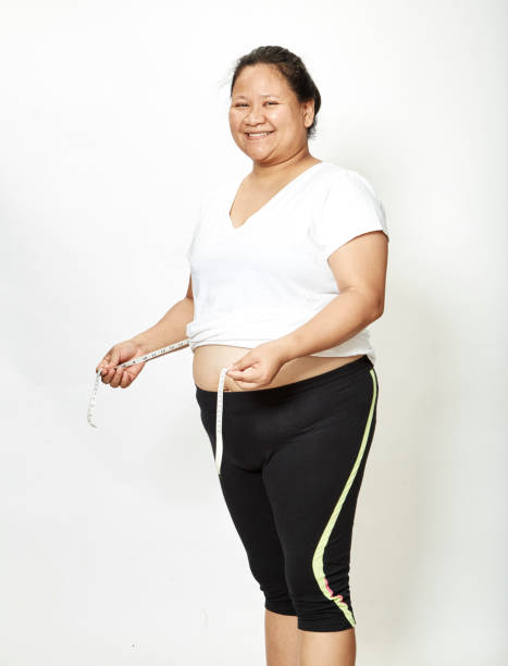 fat young woman asian with measure tape on white background. - 3666 imagens e fotografias de stock