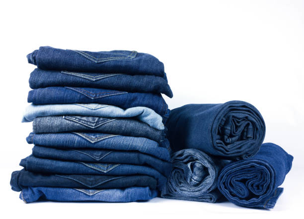 istock jeans stacked isolated on white background. 1046465134