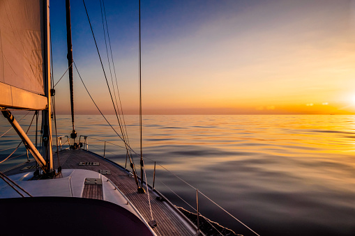 Tranquil scene of the sea at sunset onboard a sailboat in the Atlantic ocean. UK Southern coast