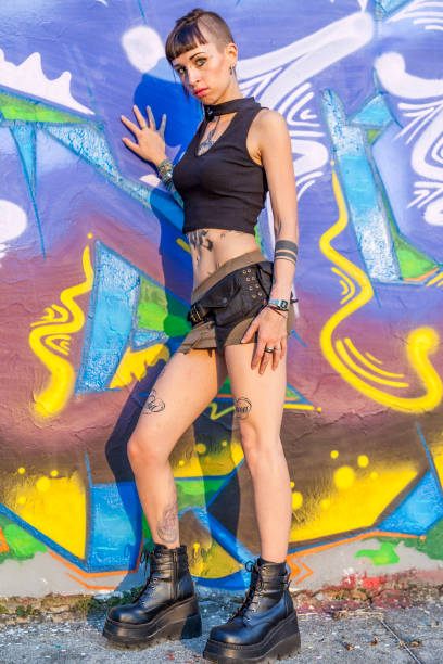 istock tattooed rebel girl posing against a wall 1046475350