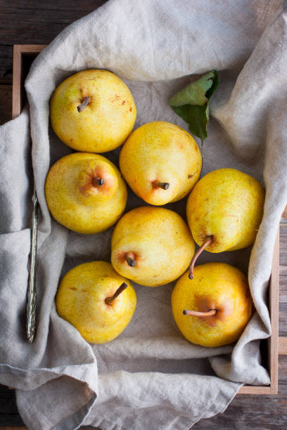 istock Chopped fresh yellow pear on a wooden board, top view, selective focus Fruit background. 1046482810