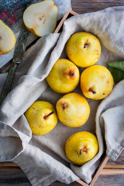 istock Chopped fresh yellow pear on a wooden board, top view, selective focus Fruit background. 1046484882