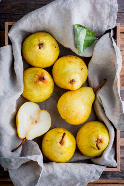 istock Chopped fresh yellow pear on a wooden board, top view, selective focus Fruit background. 1046484890