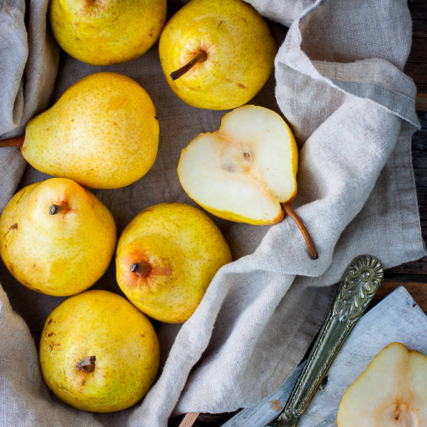 istock Chopped fresh yellow pear on a wooden board, top view, selective focus Fruit background. 1046484938