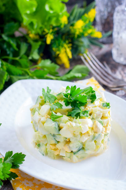 istock Fresh salad with cucumber, celery and eggs on a white porcelain plate, selective focus 1046488308