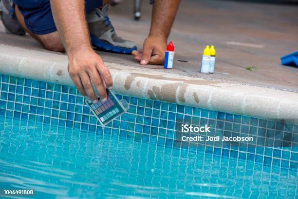 Pool Testing Kit Being Used In A Swimming Pool Stock Photo - Download Image Now - Swimming Pool, Cleaning, Chemical
