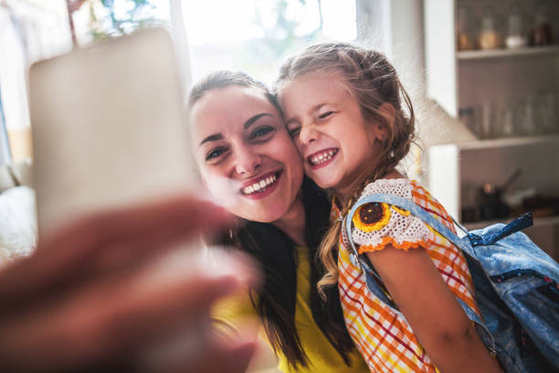 istock Young beautiful mother and daughter taking selfie 1046492252