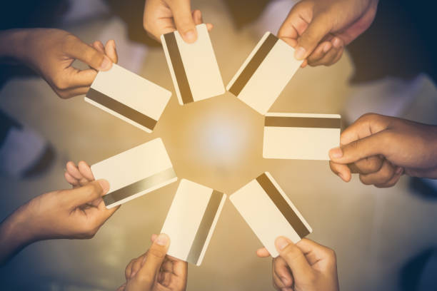 istock Group credit card or smart card show on hand holding 1046499584