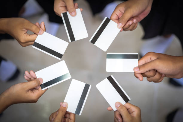 istock Group credit card or smart card show on hand holding 1046499770