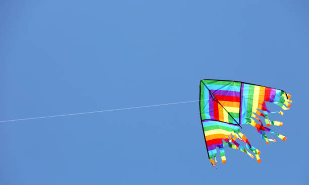istock multicolored kite flyies on the blue sky 1046502028