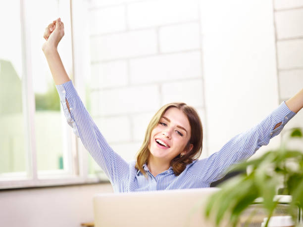 istock young caucasian corporate executive stretching arms in office 1046502114