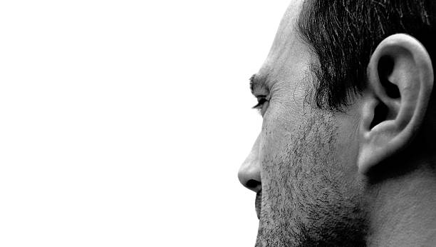 Black and white closeup face of mature man, background with copy space, full frame horizontal composition