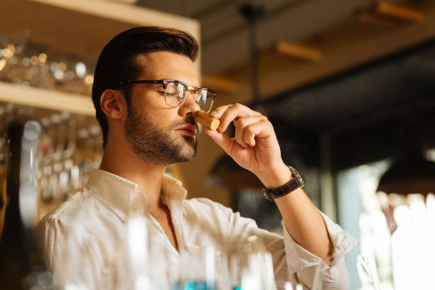 istock Pleasant handsome man putting a cork to his nose 1046510996
