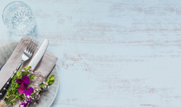 istock Rustic table setting with purple flowers on light wooden table. 1046511168