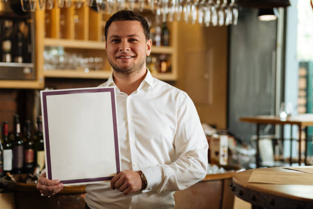 istock Professional nice male sommelier holding his diploma 1046511280
