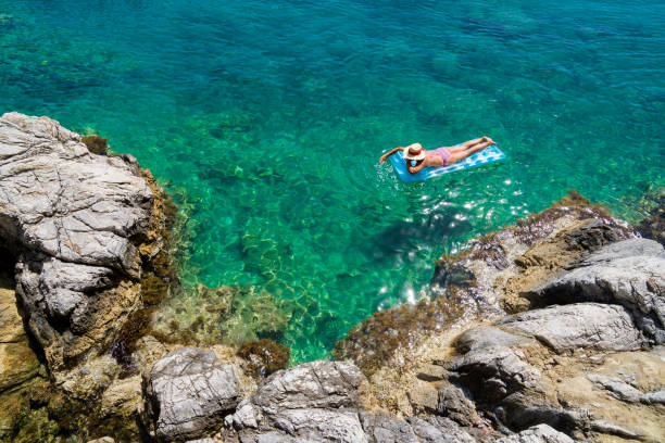 Women is sunbathing on the seabed.
