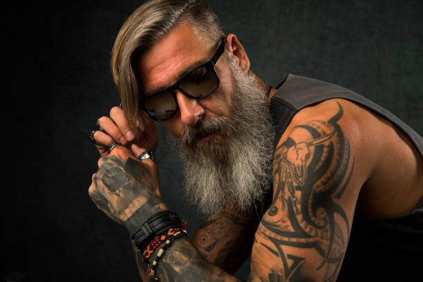 Portrait of a cool biker with sunglasses Portrait of a cool biker with sunglasses shoulder tattoo designs for men stock pictures, royalty-free photos & images