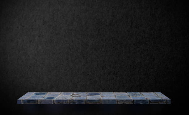 istock Gray stone rock shelf on black texture wall mock up 1046518782