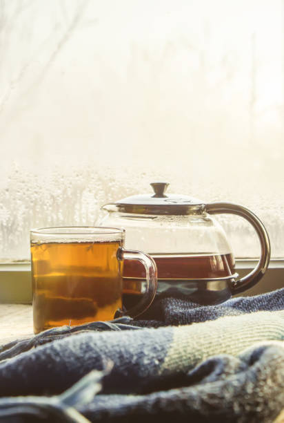istock hot tea in the pot near the window. selective focus. 1046518818