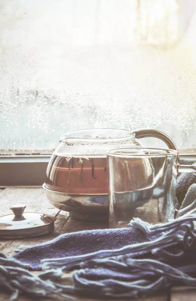 hot tea in the pot near the window. selective focus.