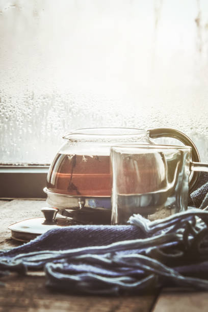 hot tea in the pot near the window. selective focus.
