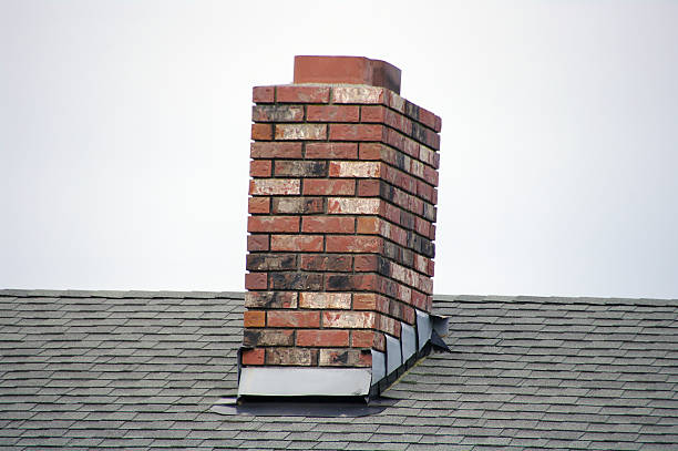 A brick small chimney on a roof A red brick masonry chimney on a residential home. chimney stock pictures, royalty-free photos & images