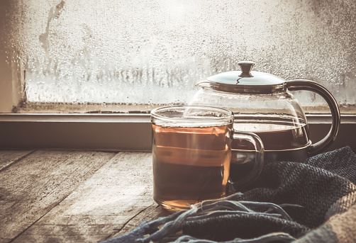 hot tea in the pot near the window. selective focus.