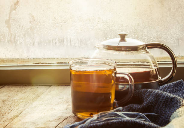 hot tea in the pot near the window. selective focus.