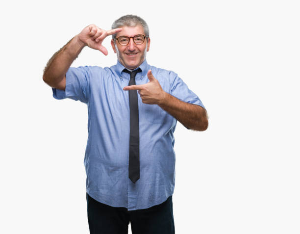 istock Handsome senior business man over isolated background smiling making frame with hands and fingers with happy face. Creativity and photography concept. 1046521950