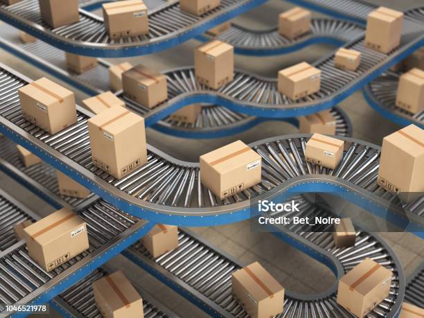 Cardboard Boxes On Conveyor Roller In Distribution Warehouse Delivery And Packaging Service Concept Background Stock Photo - Download Image Now