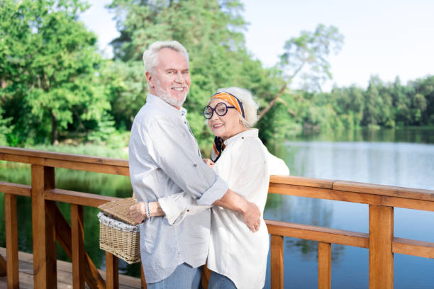 istock Two beaming pensioners smiling broadly feeling excited for picnic 1046522602