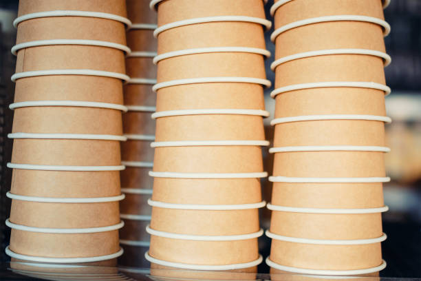 istock paper cups for coffee stacked in row closeup 1046524062