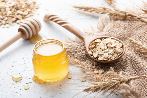 Wheat, honey and rolled oats. Concept of healthy eating, healthy lifestyle, dieting, weight loss food
