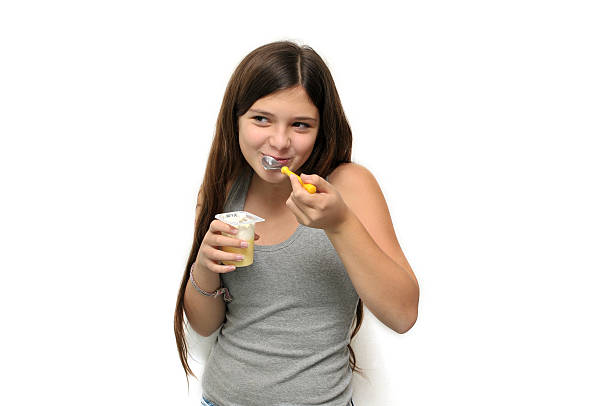 Girl with yogurt stock photo