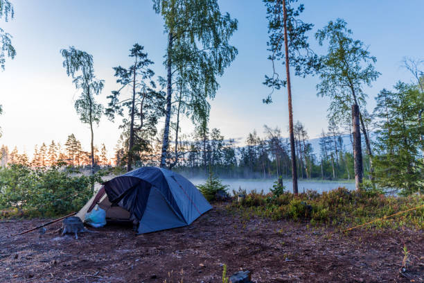 istock Camping tent near lake outdoors activity 1046544050