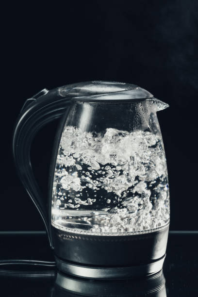 istock electric glass kettle on blue background 1046549014