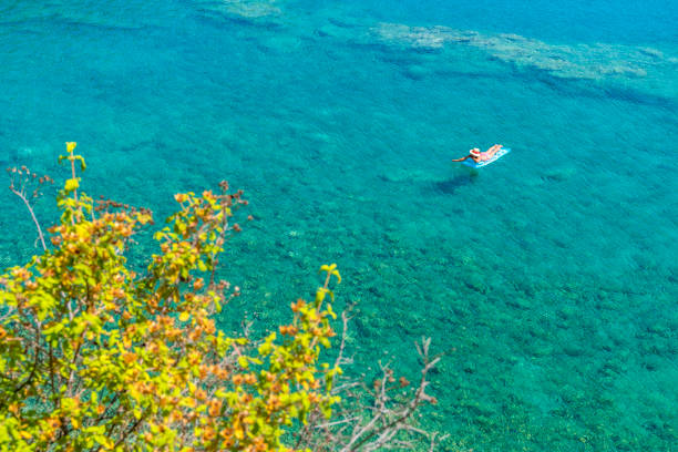 Women is sunbathing on the seabed.