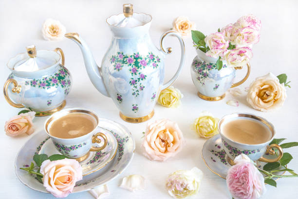 istock Beautiful coffee set with rose flowers on white background 1046554354