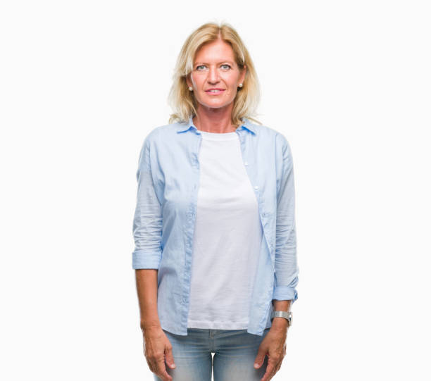 istock Middle age blonde woman over isolated background with serious expression on face. Simple and natural looking at the camera. 1046554472